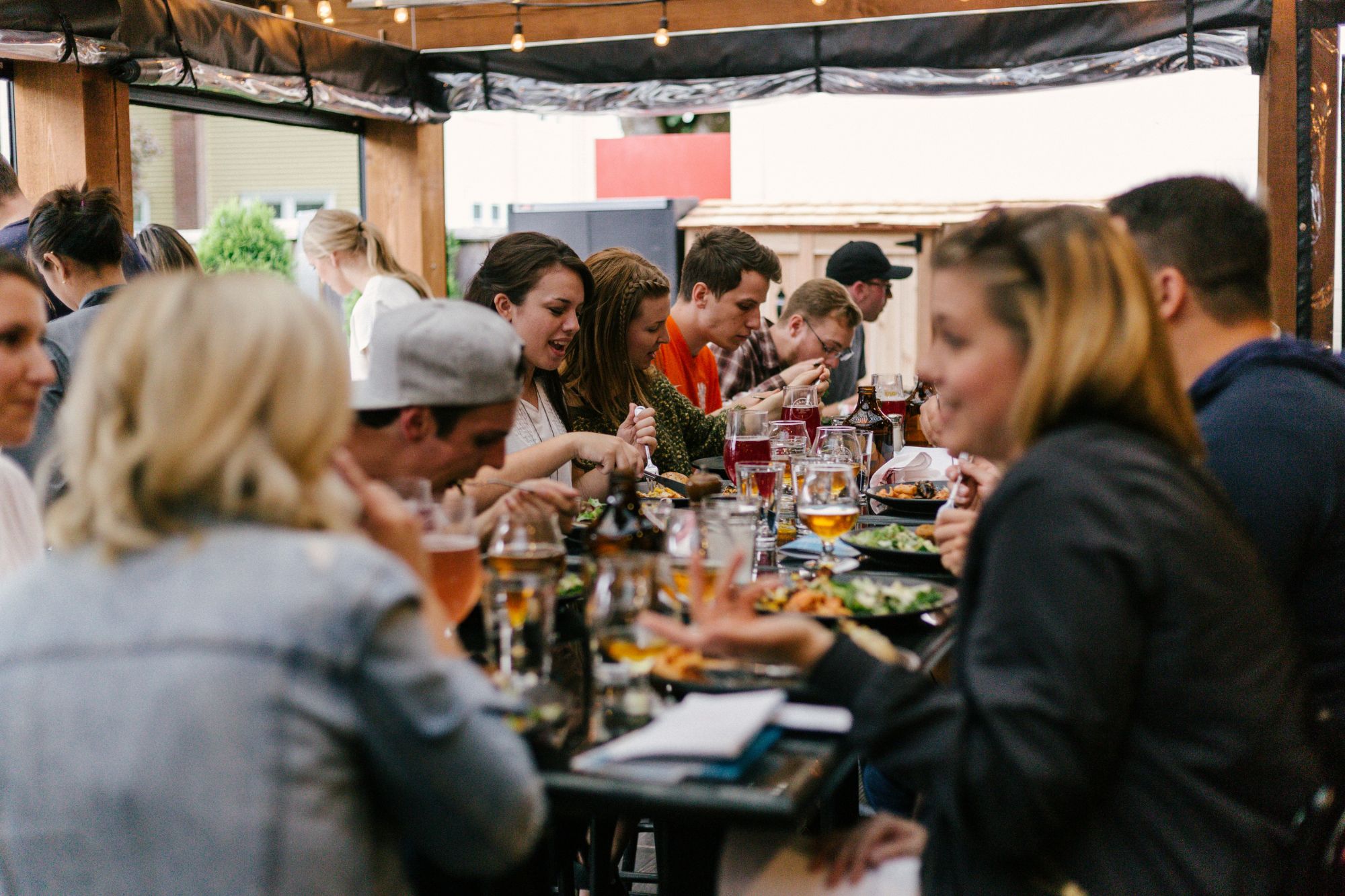 Agency owners mid-conversation over dinner, not looking at the camera